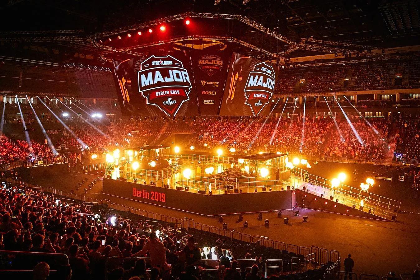 Vibrant CS2 Major arena with Team Vitality players celebrating on stage amid roaring cheering crowd, esports tournament atmosphere